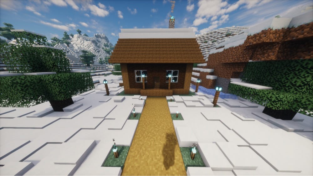 Dark wood cabin in a snowy valley with a plank roof capped in snow, a chimney giving off a blue soul campfire flame and smoke, windows beside the door, and soul lanterns on posts along the path to it.