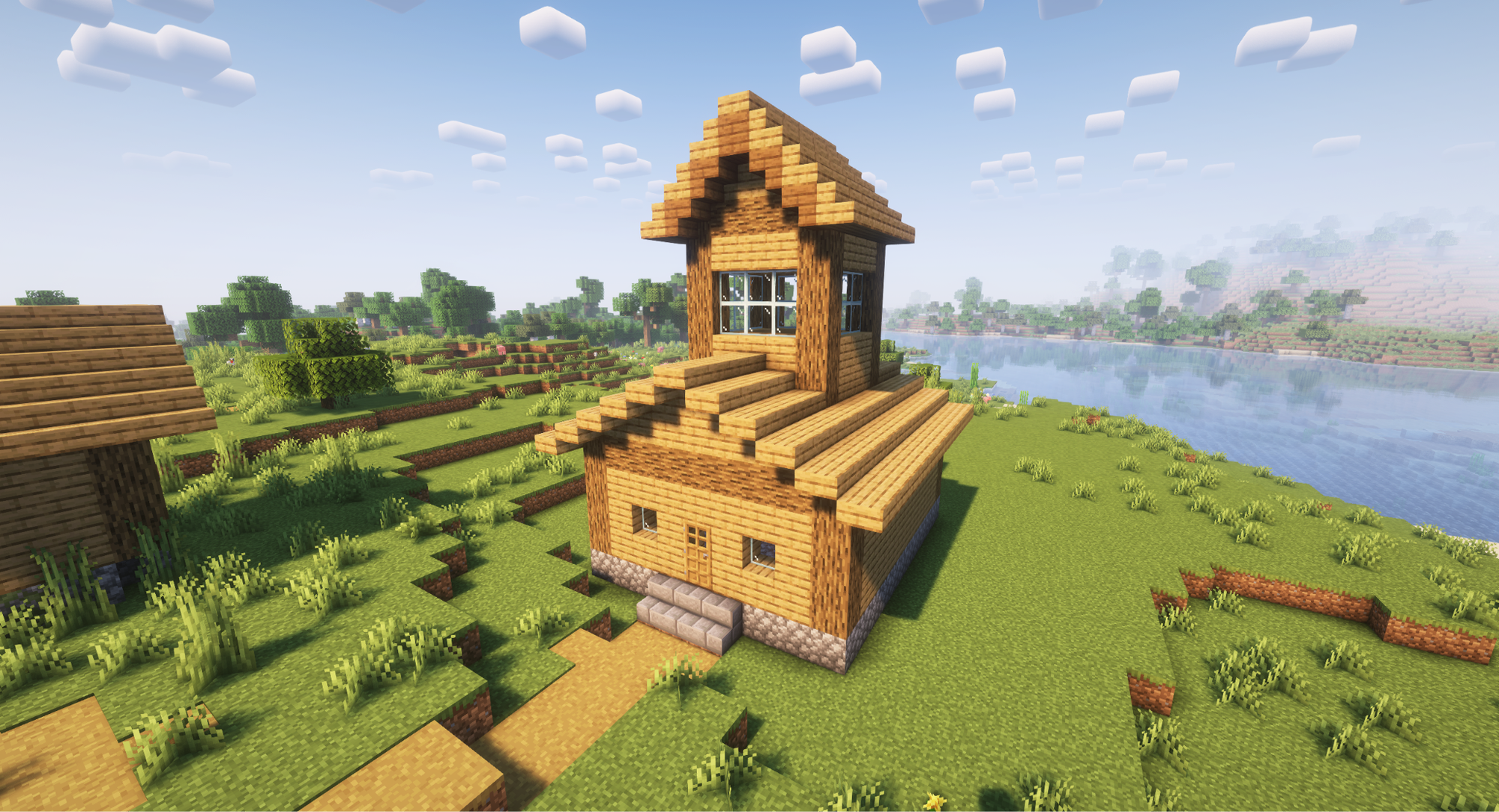 A Minecraft screenshot of a house with a monitor style roof.