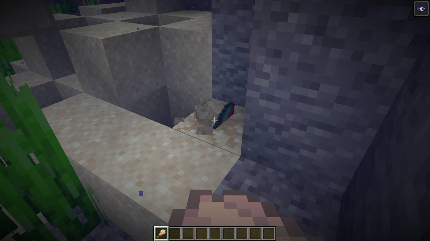 Brushing a suspicious sand with Sniffer egg coming out in a dim underwater passage within the ruin, sandstone visible nearby.