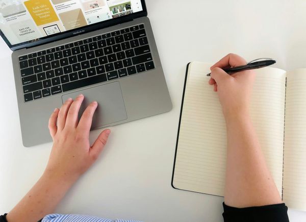 A creator typing on a laptop building a project