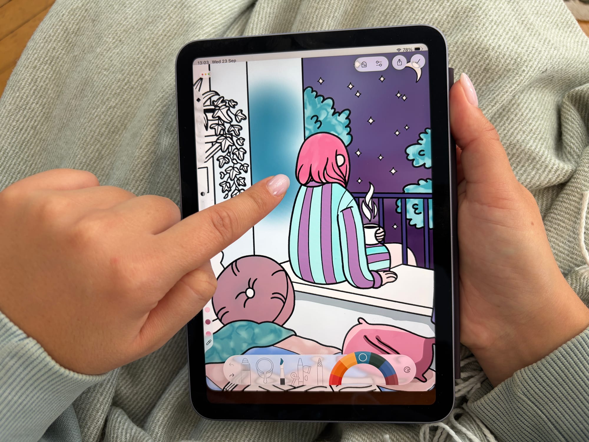 Finger coloring an iPad artwork by Pan Peekabo in the Lake coloring app