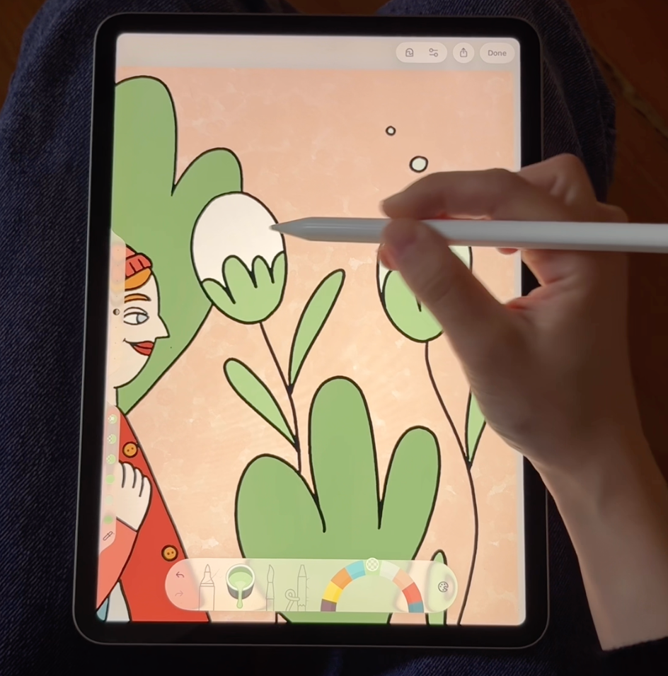 A hand coloring a detailed illustration in Lake, a digital coloring app for iPad and iPhone.