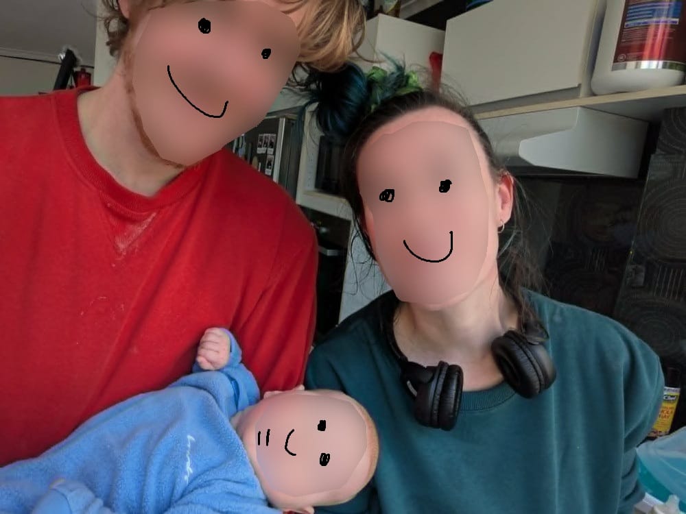 An image of two parents holding their newborn