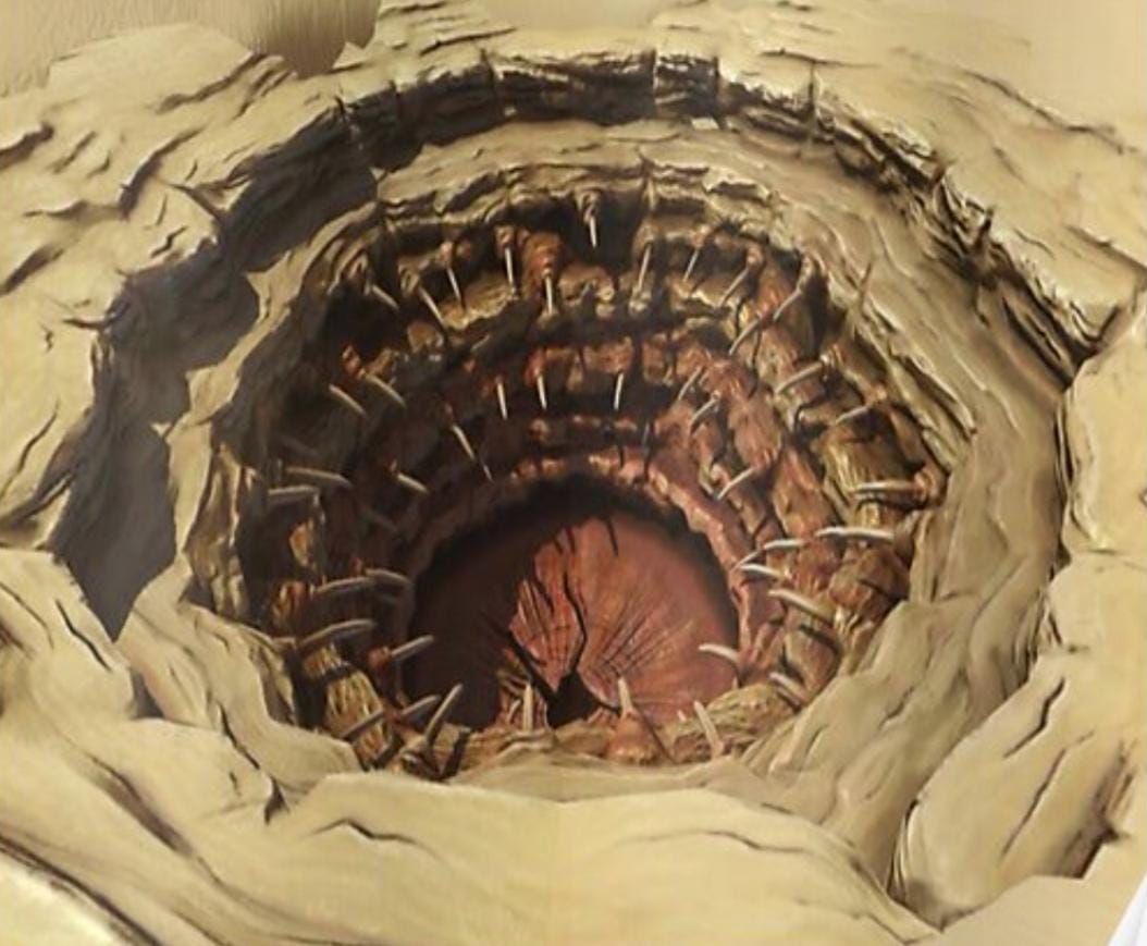 An image of the Sarlacc pit from Star Wars. A rocky pit is lined with barbed spines
