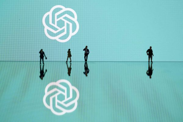 This photograph shows figurines next to the ChatGPT logo