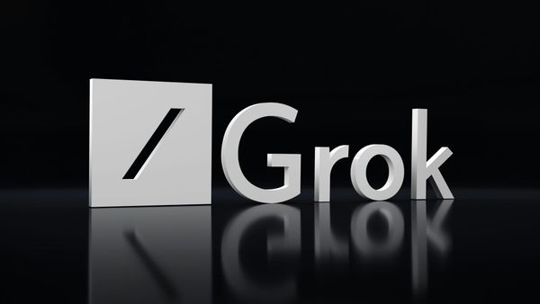 The Grok logo and wordmark in gray mirrored against a black backdrop