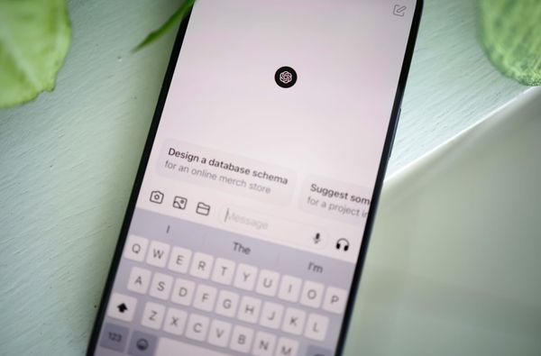 ChatGPT open on a phone which is angled and laying on a green table.