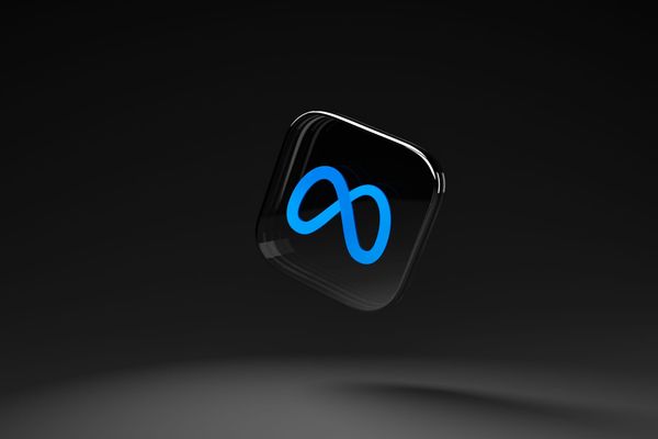 The Meta logo in blue on a 3D black tile floating in black space