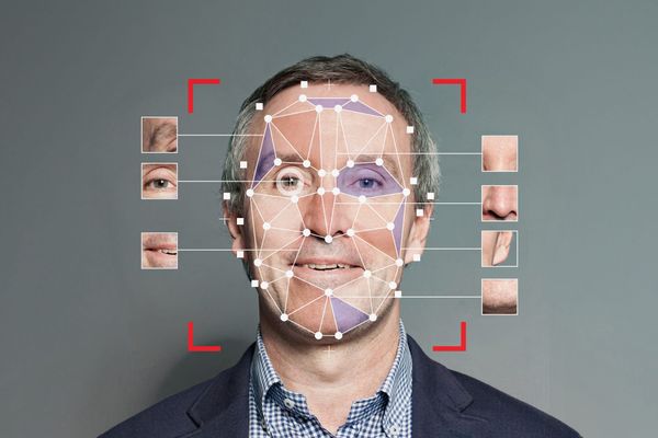 Concept art of a facial recognition system identifying many points of a man's face, with exploded diagrams of various facial features