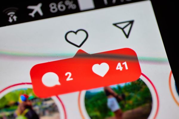 A close-up of a notification showing new messages in Instagram, shown on a smartphone