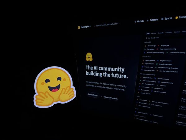 The Hugging Face logo next to its website