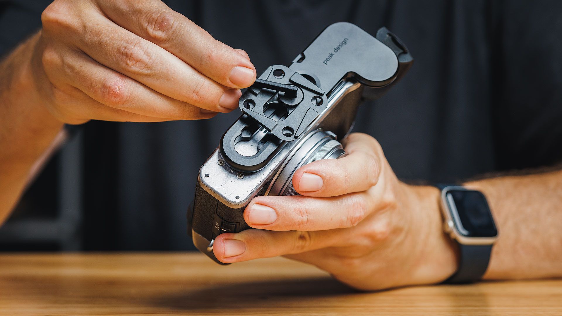 Mounting the Peak Design Micro Clutch to the bottom of a Fuji X100 camera