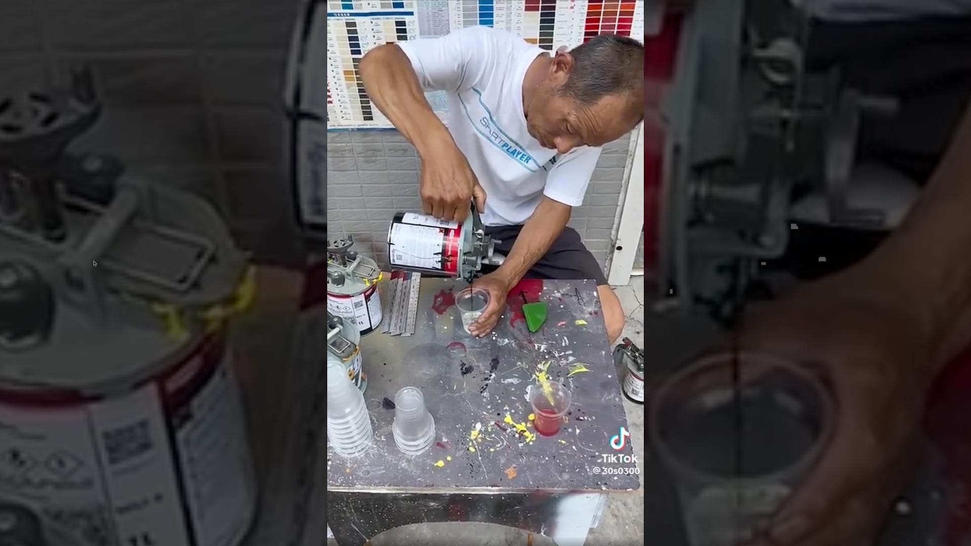 Color matcher mixing paint on the street