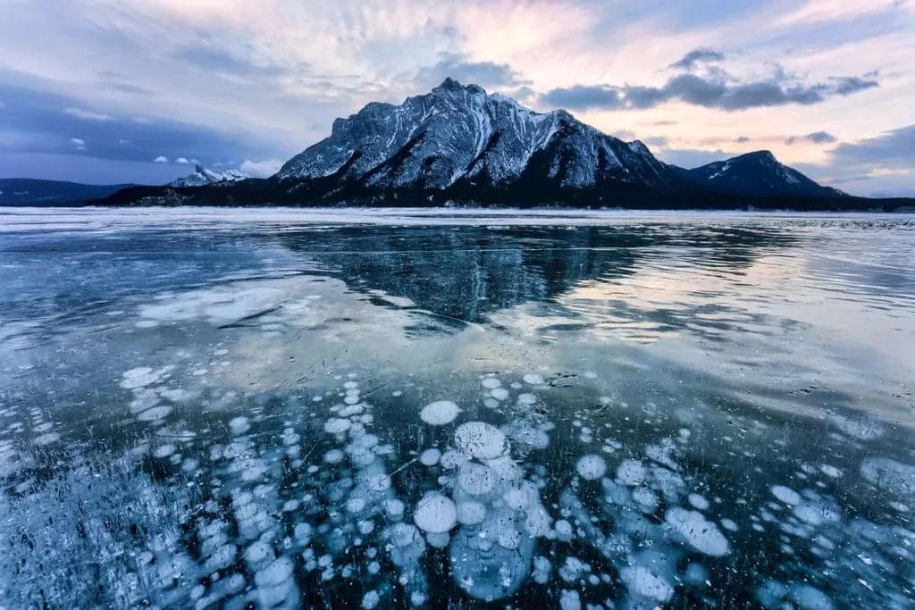 Frozen Abraham Lake Ice Bubbles In Winter With Mountain Backdrop Alberta Canada
