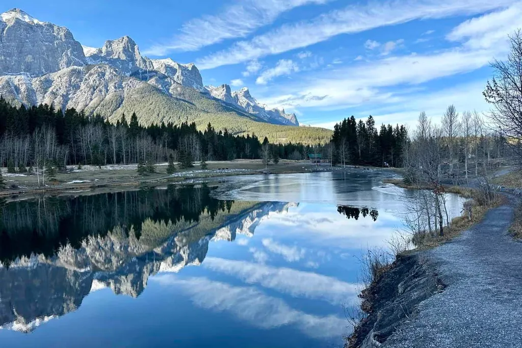 Rocky Mountains Are Reflected In A Calm Quarry Lake Canmore Alberta Canada
