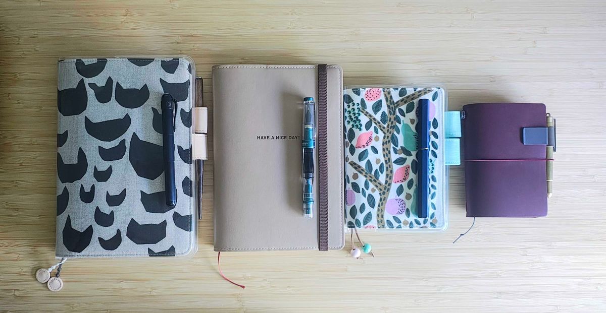 A selection of notebooks and fountain pens