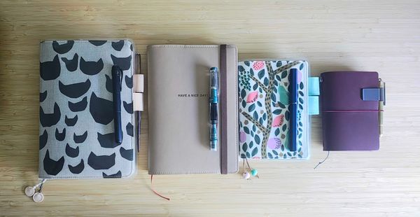 A selection of notebooks and fountain pens