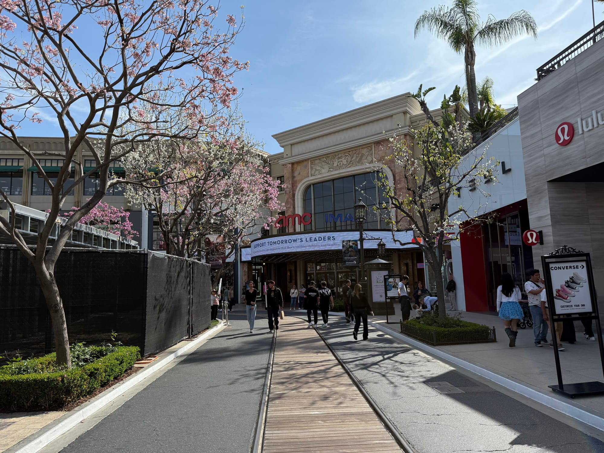The car-free street of the Americana with a construction site blocking access to the left and Tesla showroom to the right