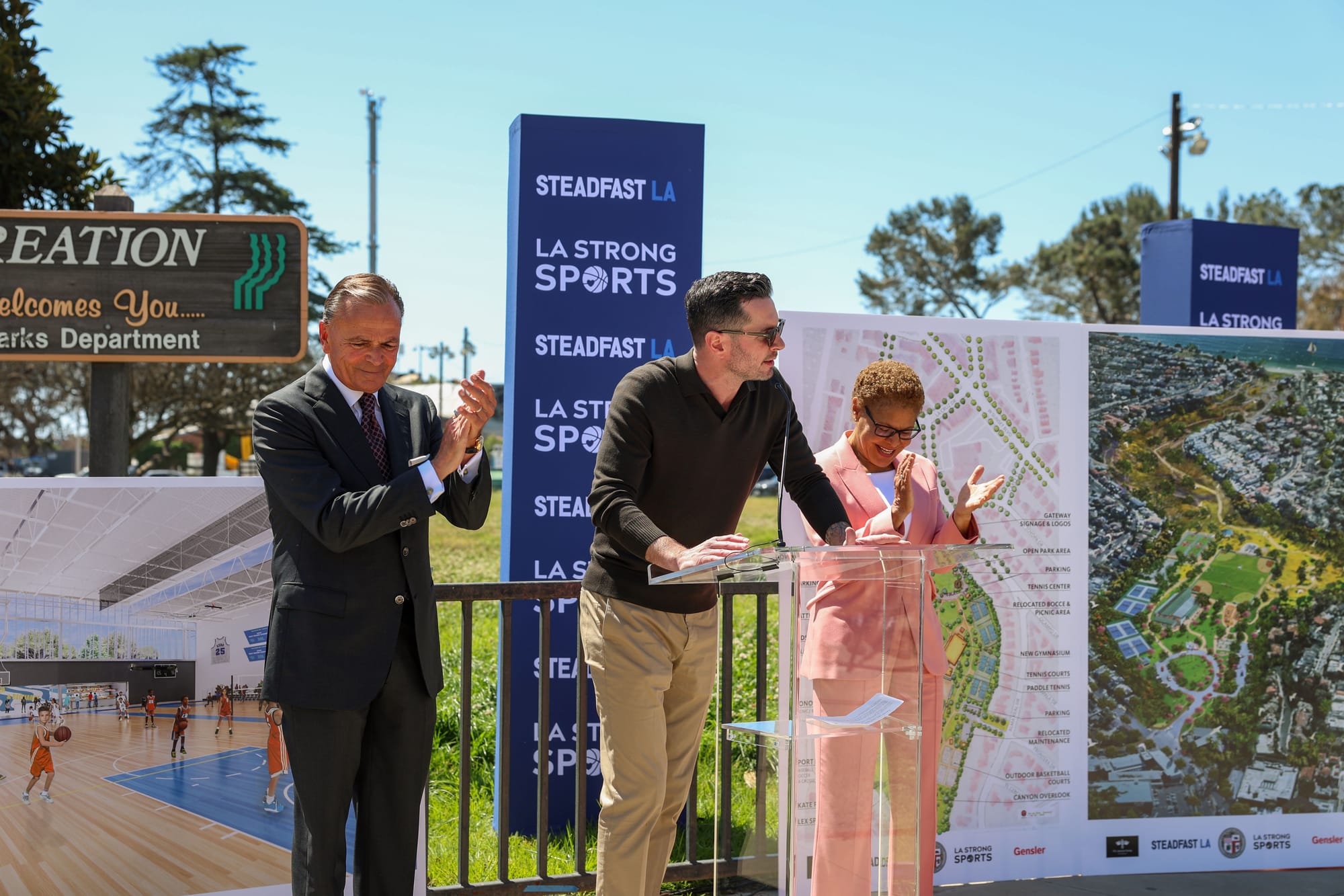 Rick Caruso, JJ Redick, and Karen Bass standing before renderings and site plans of the new Palisades rec center