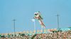 A man in a white jumpsuit and a jetpack sails above the crowds at the opening ceremonies of LA's 1984 Olympics