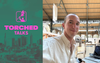 A graphic for the Torched Talks event with the Torched logo and a photo of Henry in the Paris 2024 media center