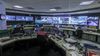 A large room labeled Automated Traffic Surveillance and Control that's covered in monitors showing streets across LA 