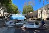 Two young kids running around a garden space at Hollywood High courtyard with a blue mural behind it