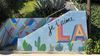 A staircase on an LA hillside painted in brightly colored patterns and cactuses with the phrase: je t'aime LA