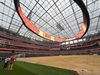 A view from a dirt field level at SoFi Stadium showing the graphics for LA's World Cup logo and "we are 26"