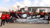 SoFi workers line up outside the stadium holding a banner that reads Kick ICE out of the World Cup