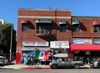A corner soccer store with a Mexico flags out front and flag bunting strung up on the streetsigns