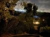 The Hollywood Sign high in the hills is lit up by a series of projectors coming from a nearby house