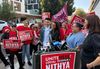 Unite Here union members in red shirts and holding endorsement signs surround LA mayoral candidate Nithya Raman