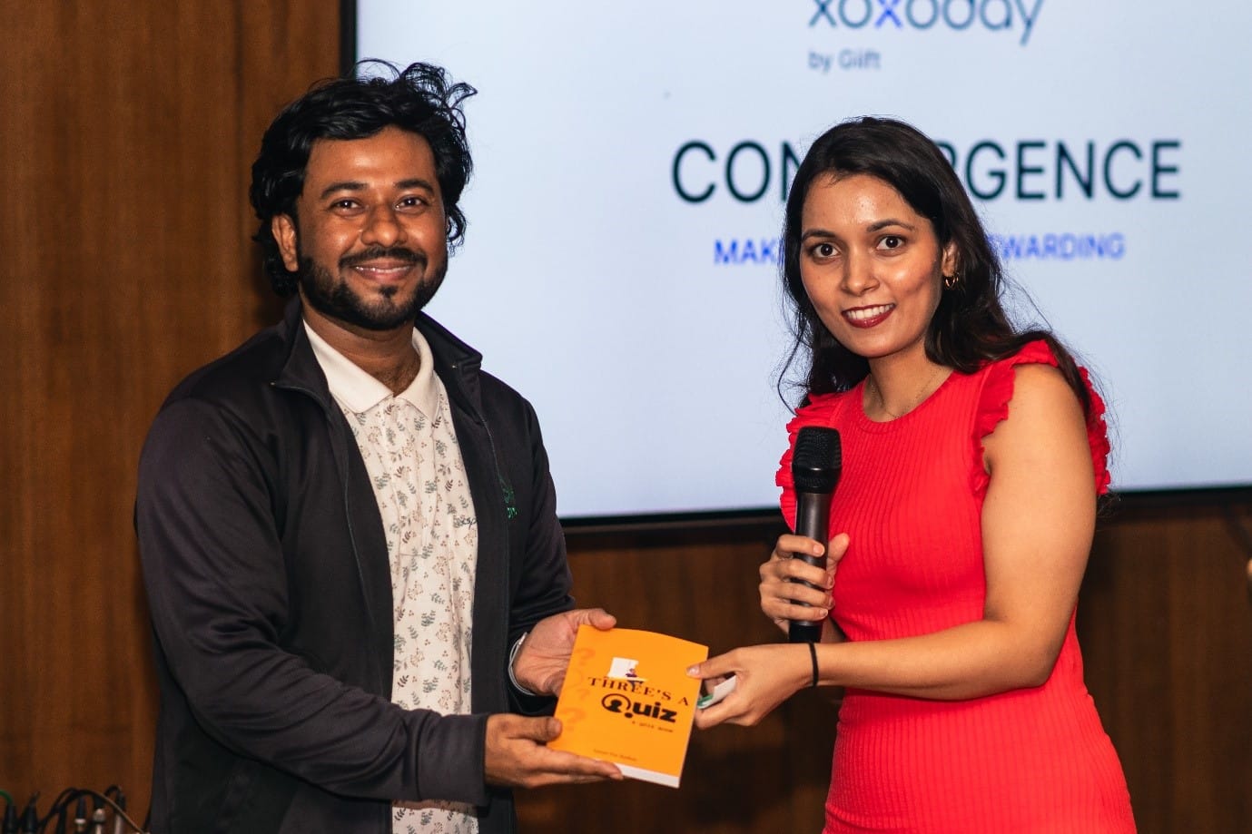 A person and person holding microphones and talking