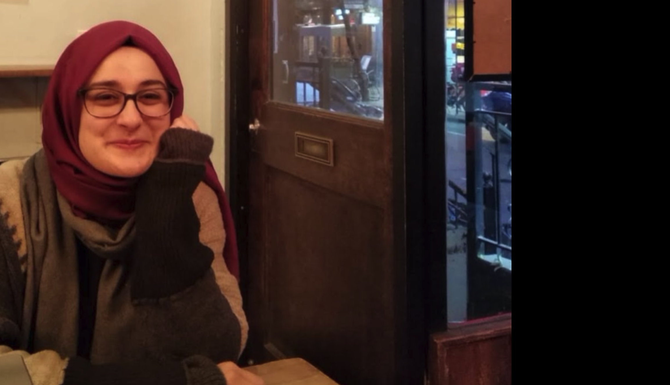 Image of Rumeysa Ozturk smiling as she sits relaxed at a table in a store.