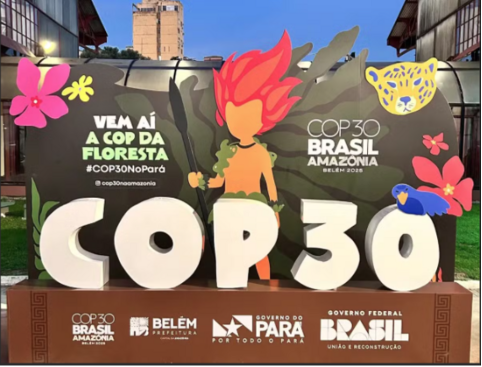 A billboard sign announcing with flashy graphics the COP30 climate summit.