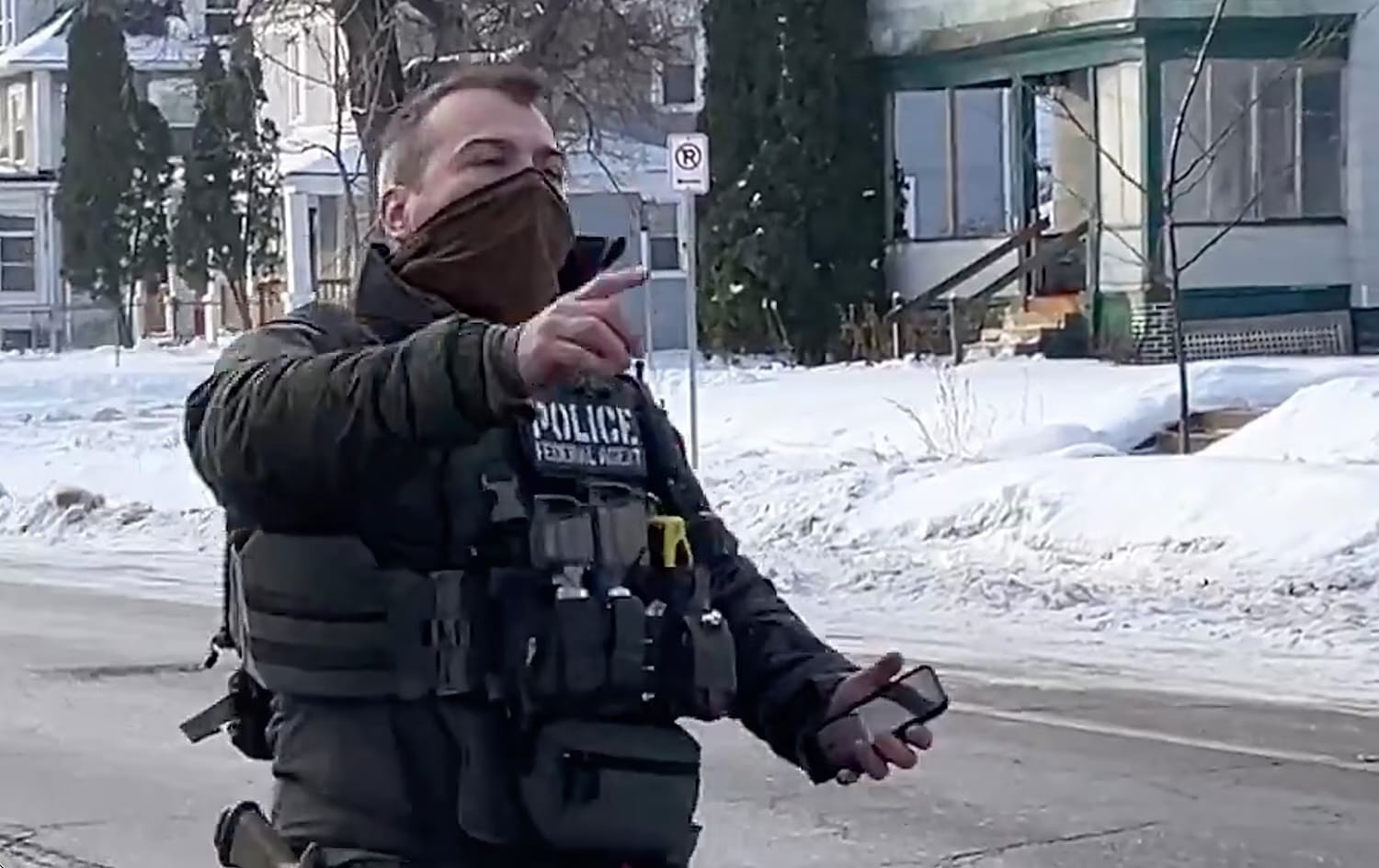 ICE agent Jonathan Ross walks away following the shooting of Renee Good