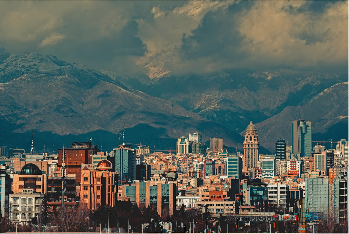 Photo of Tehran with mountains in the background, by Sajad Nori/via Unsplash