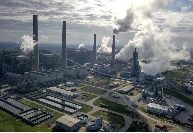 Lots of smokestacks at power plant.