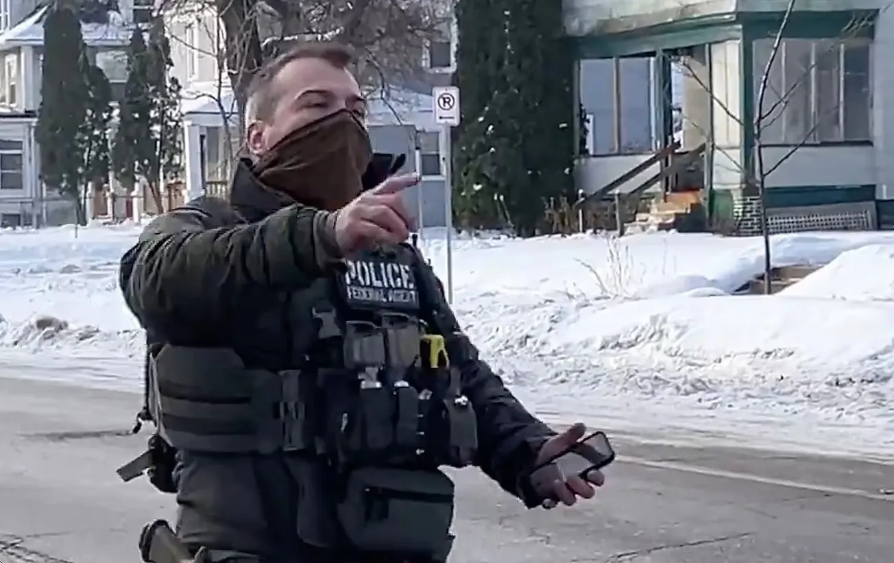 ICE agent Jonathan Ross walks away following the shooting of Renee Good