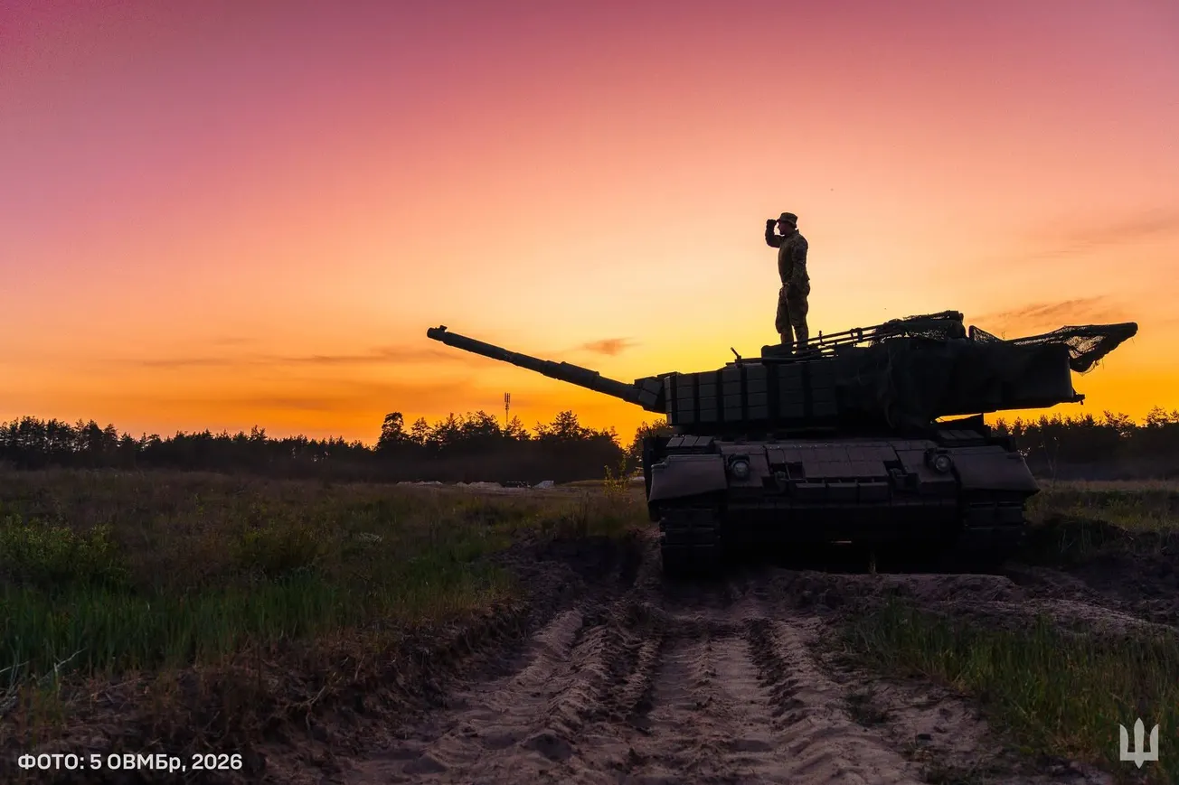 Soldier standing on tank.