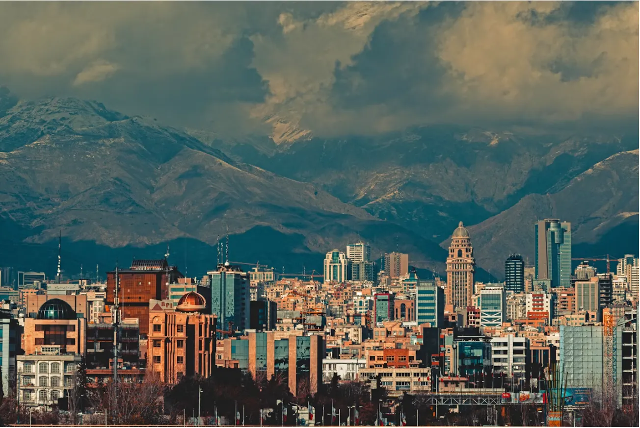 Photo of Tehran with mountains in the background, by Sajad Nori/via Unsplash