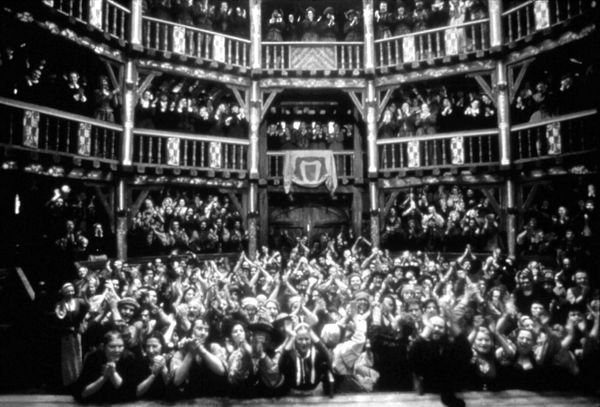A black and white photograph of a rapturous audience in a packed theater.