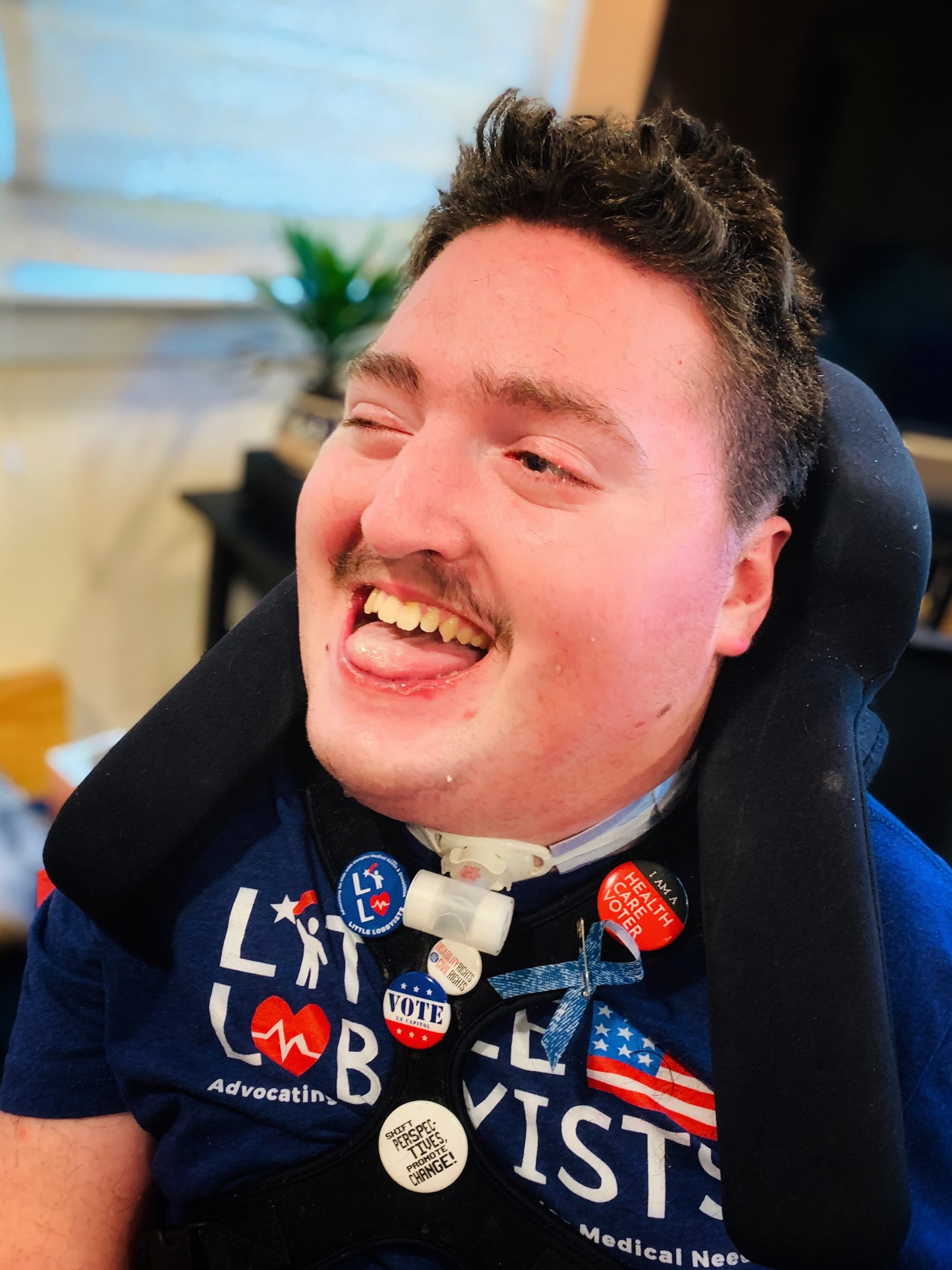 Rob Stone, now 23 years old, supporting Little Lobbyists & showing off all his advocacy pins