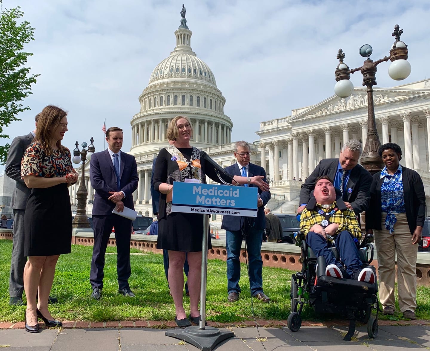 Jeneva with her son Robert and husband Roger advocating for Medicaid in front of the Capitol with members of Congress and Little Lobbyists mom Laura.