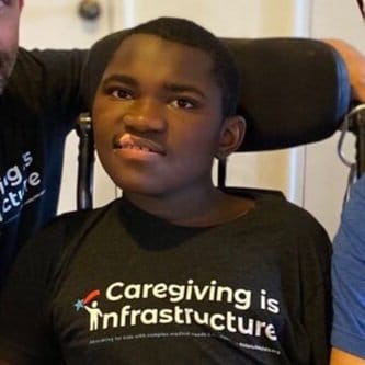 Ravi an African American teenager wearing a  little lobbyists shirt