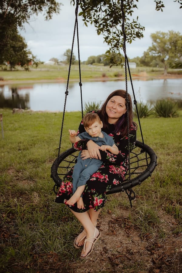 Mel Sabin and her friend Logan enjoying a swing