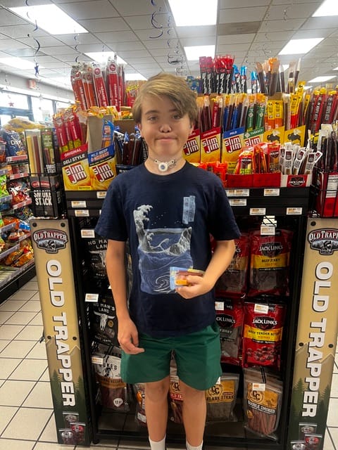 James smiling in a convenience store.