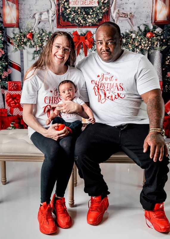 Jayden and his parents posing for a Christmas photo