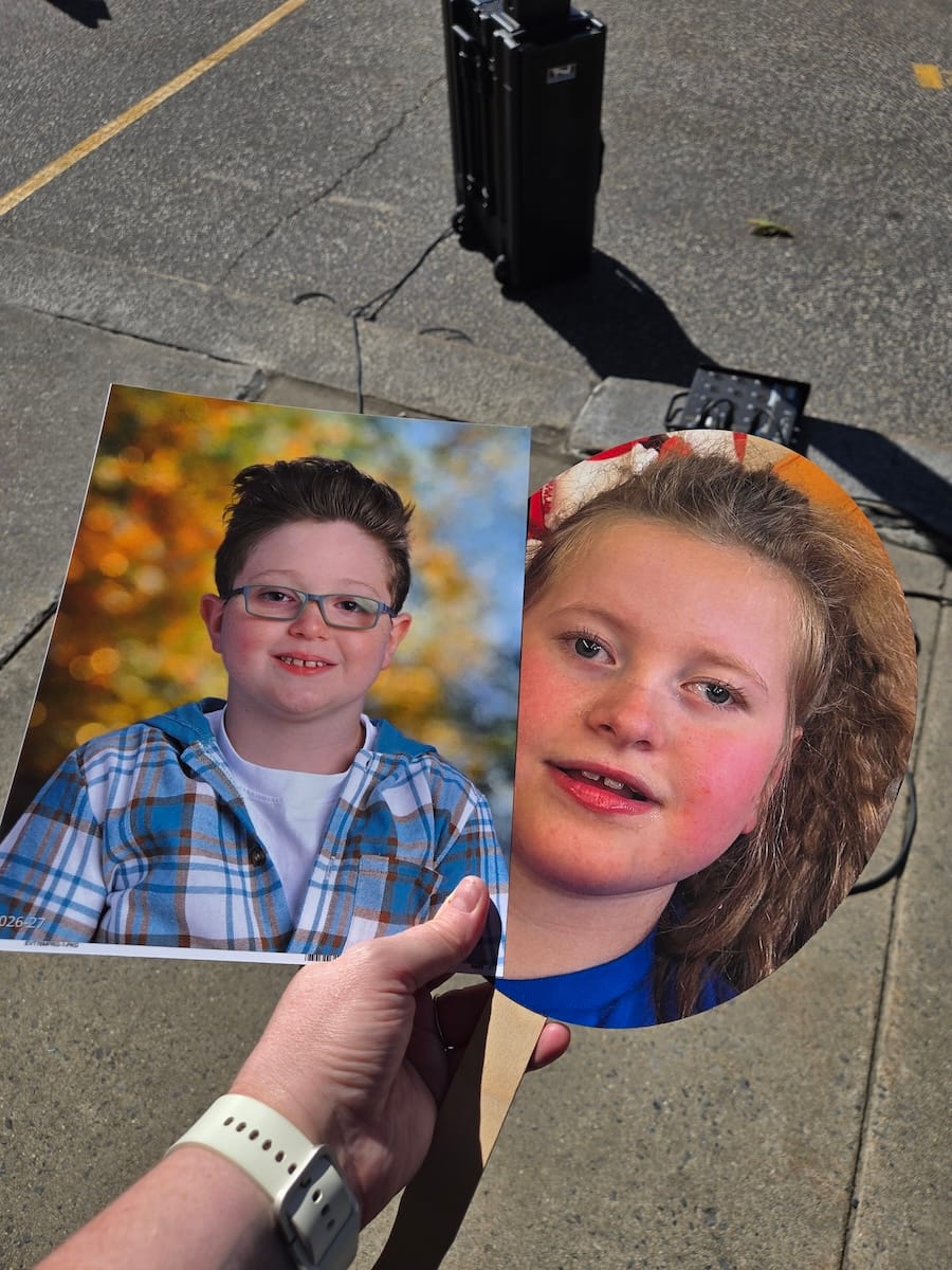Victoria holds up photographs of her son Cole and Chelsea Anders' daughter Olivia.